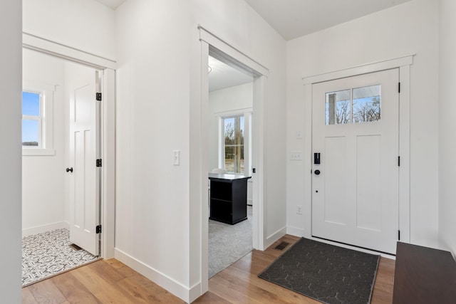 view of carpeted foyer entrance