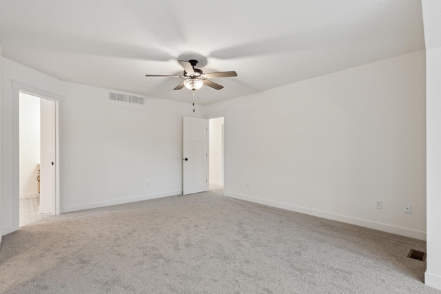 spare room with ceiling fan and light carpet