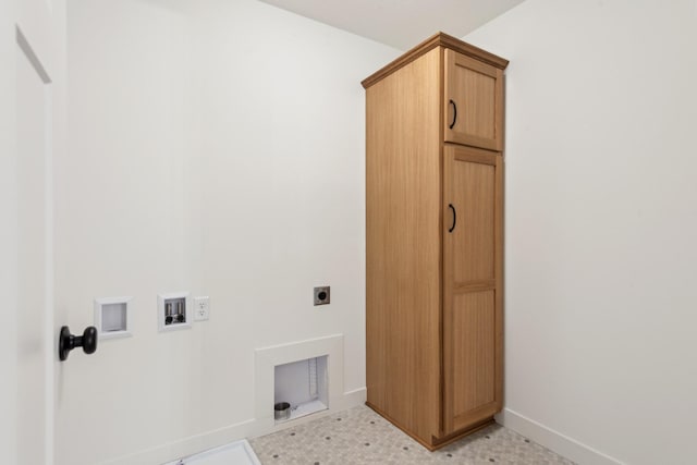 washroom featuring light tile flooring, washer hookup, hookup for an electric dryer, and cabinets