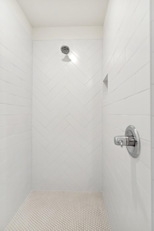 bathroom with a tile shower