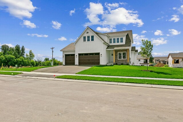 view of front facade featuring a front lawn and a garage