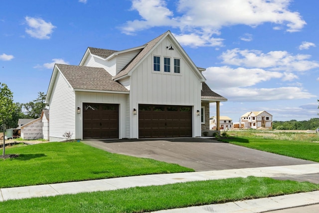 view of front facade with a front yard and a garage