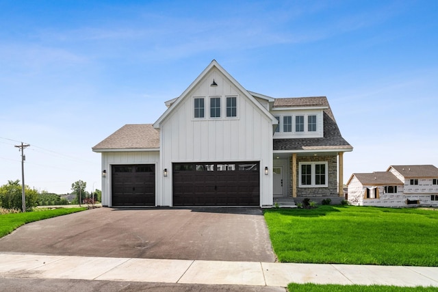 modern farmhouse style home featuring a front lawn and a garage