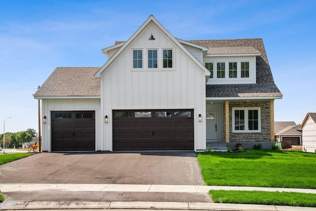 modern farmhouse with a front lawn and a garage