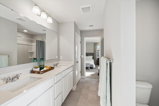 bathroom featuring vanity, toilet, and walk in shower