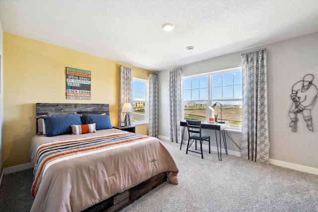 bedroom featuring carpet floors and a textured ceiling