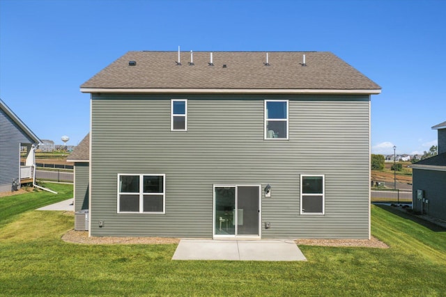 back of property with a lawn and a patio area