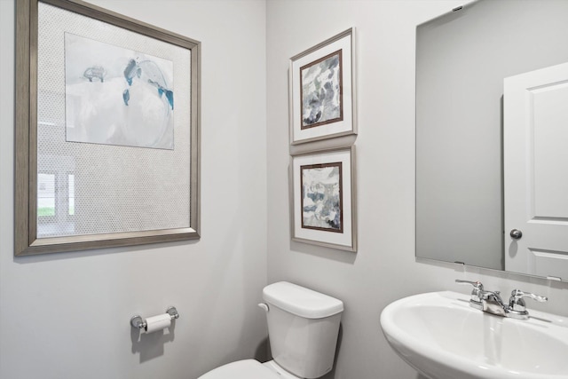 bathroom featuring toilet and sink