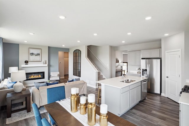 dining space with sink and dark wood-type flooring