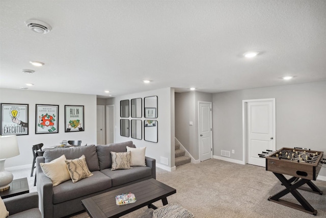 carpeted living room featuring a textured ceiling