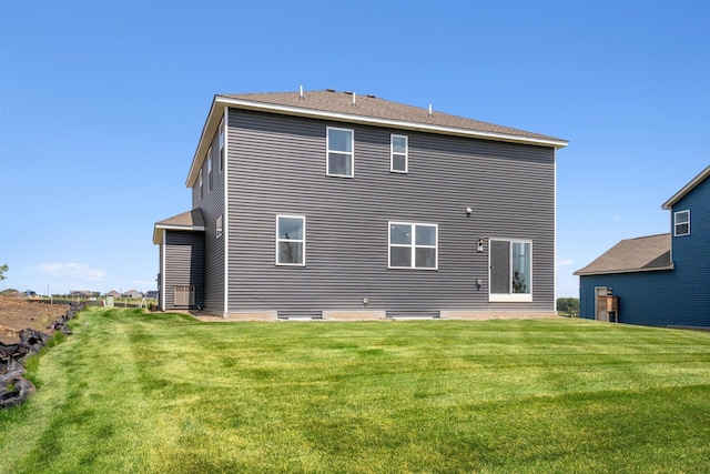 rear view of property with a yard