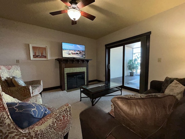 living room with light carpet, ceiling fan, and a fireplace