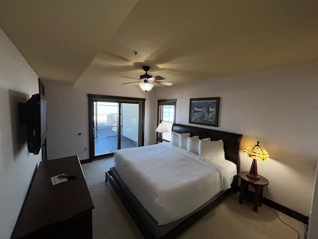 carpeted bedroom with ceiling fan and access to exterior