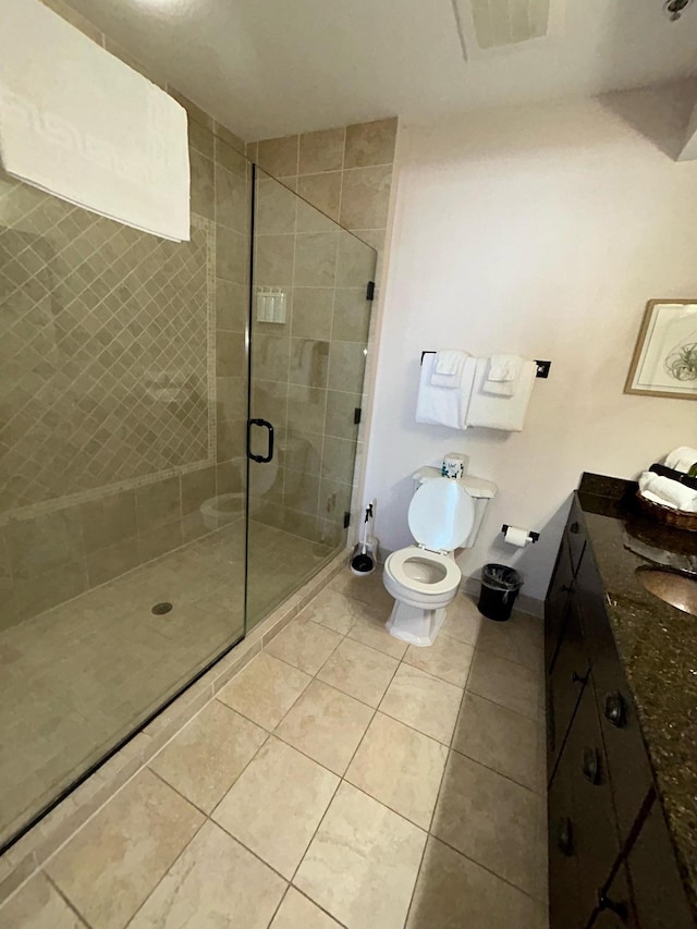 bathroom with tile floors, an enclosed shower, toilet, and vanity