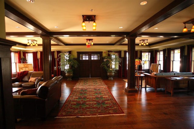 entrance foyer featuring dark hardwood / wood-style floors, decorative columns, and beamed ceiling