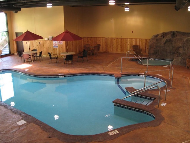 view of swimming pool featuring an indoor hot tub