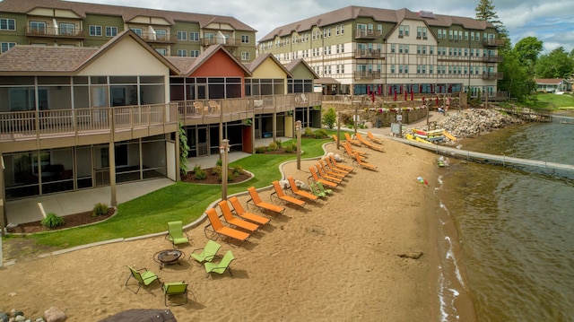 exterior space featuring a water view and a lawn