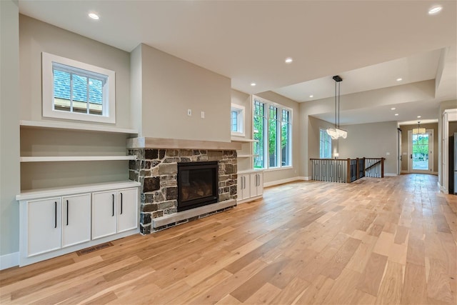 unfurnished living room featuring light hardwood / wood-style floors and a fireplace