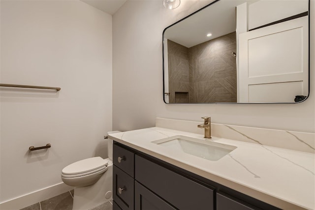 bathroom featuring tile floors, toilet, and large vanity