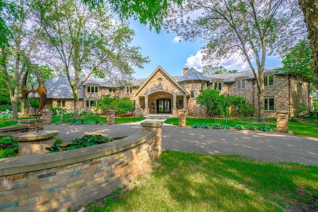 view of front of property with french doors and a chimney