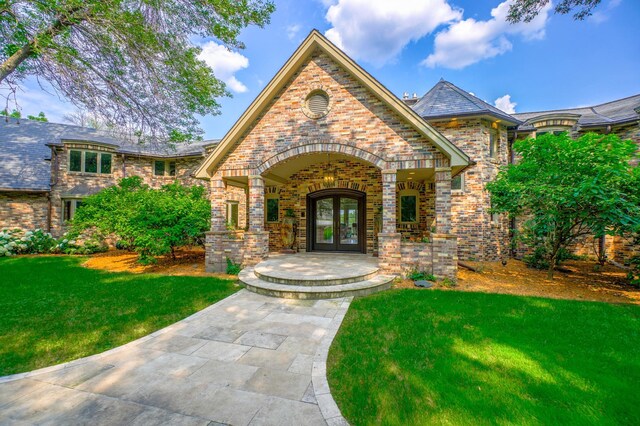 view of front of property featuring a front lawn and french doors