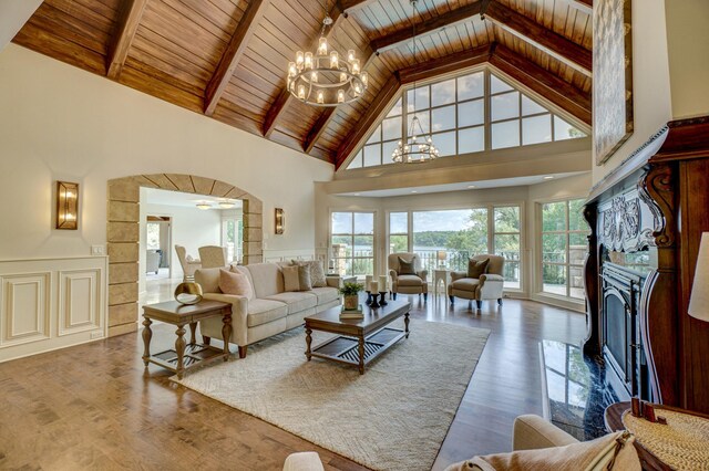 living room featuring wood ceiling, beamed ceiling, hardwood / wood-style floors, and high vaulted ceiling