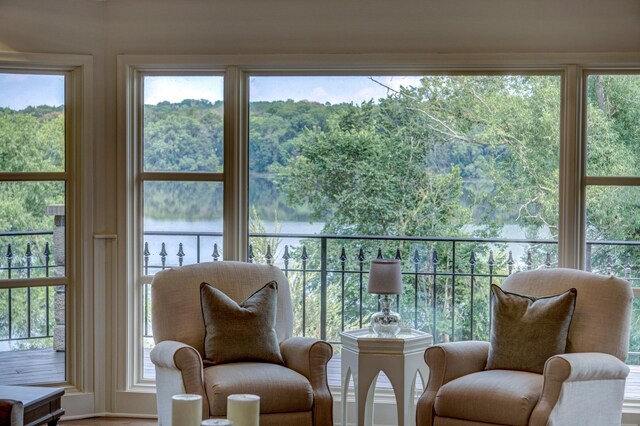 sunroom / solarium with plenty of natural light and a water view