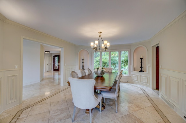 dining space featuring light tile patterned floors, crown molding, and a notable chandelier