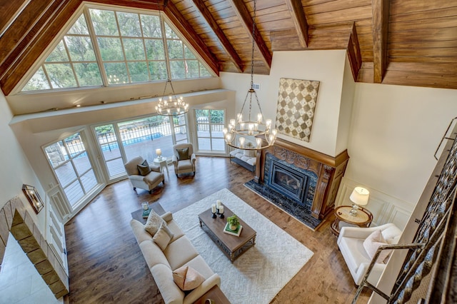 living room featuring plenty of natural light, beam ceiling, and wooden ceiling