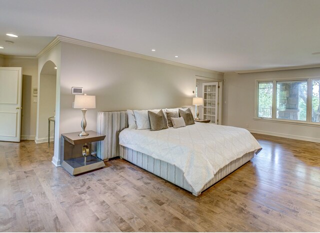 bedroom with hardwood / wood-style floors and ornamental molding