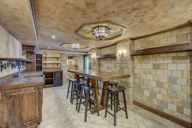 kitchen featuring sink, light tile patterned floors, and butcher block countertops