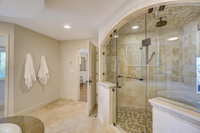 bathroom featuring an enclosed shower and tile patterned floors