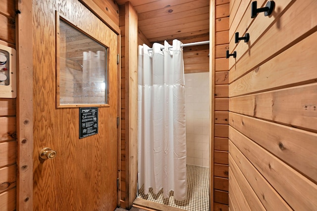 bathroom featuring wooden ceiling and wooden walls