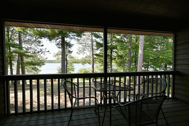 wooden terrace featuring a water view