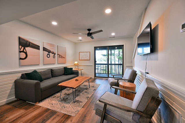 living room with ceiling fan and dark hardwood / wood-style floors