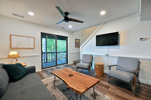 living room featuring ceiling fan and dark hardwood / wood-style flooring