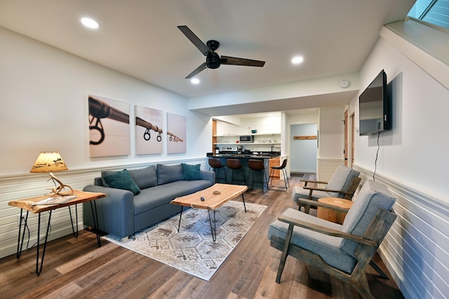 living room featuring hardwood / wood-style floors and ceiling fan