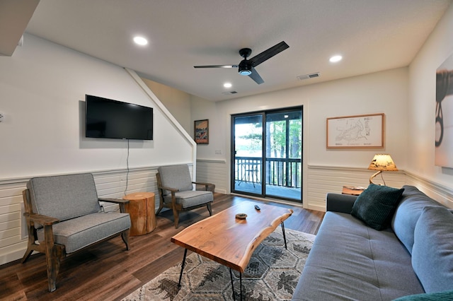 living room featuring ceiling fan and dark wood-type flooring