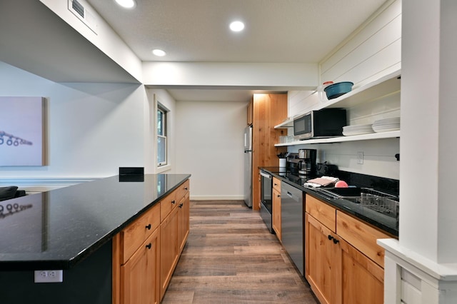 kitchen with dark hardwood / wood-style flooring and stainless steel appliances