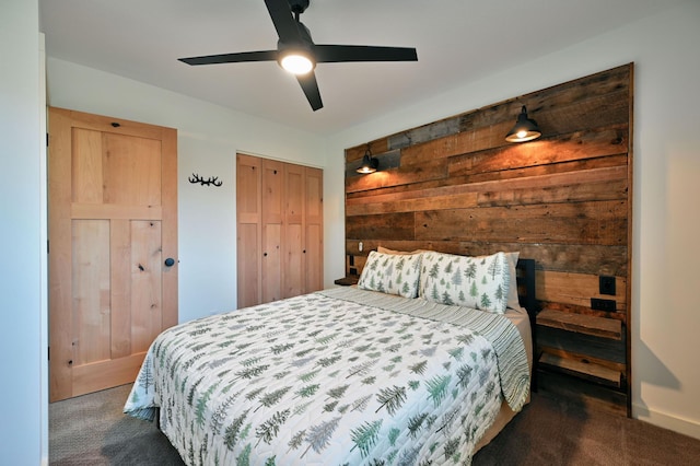 bedroom featuring ceiling fan and dark carpet