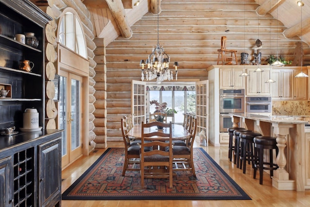 dining room featuring light hardwood / wood-style flooring, vaulted ceiling with beams, a chandelier, and french doors