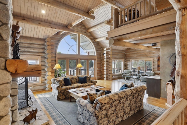 living room featuring hardwood / wood-style flooring, wooden ceiling, a healthy amount of sunlight, high vaulted ceiling, and beamed ceiling