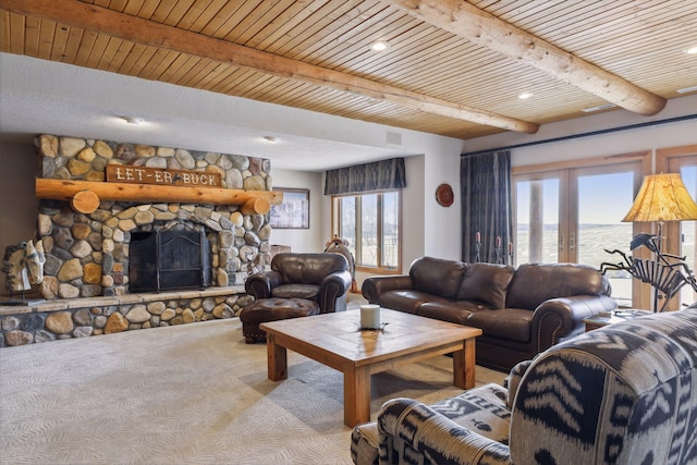 living room with a fireplace, a water view, beam ceiling, and wood ceiling