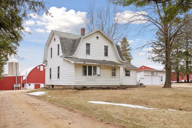 view of front of property featuring a garage and a front lawn