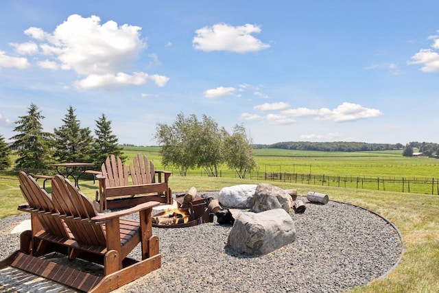 view of yard featuring a rural view and a fire pit