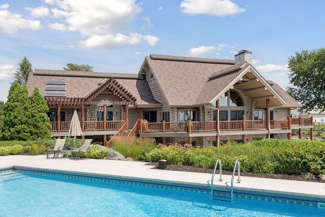 back of house featuring a pool side deck