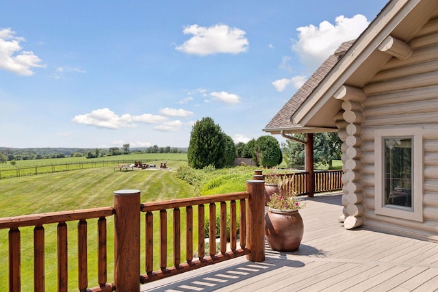 wooden terrace featuring a yard and a rural view