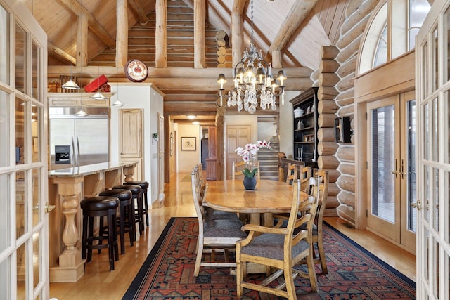 dining space with an inviting chandelier, french doors, beamed ceiling, high vaulted ceiling, and wood ceiling