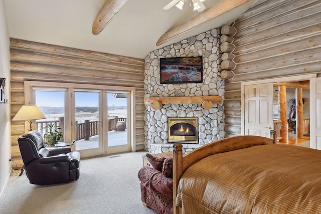 carpeted bedroom featuring lofted ceiling with beams, access to outside, and a fireplace