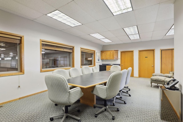 carpeted office featuring a paneled ceiling